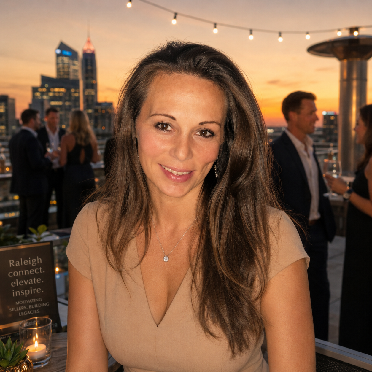 Jennifer, local Raleigh NC cash home buyer at a rooftop investor event with the Raleigh skyline at sunset