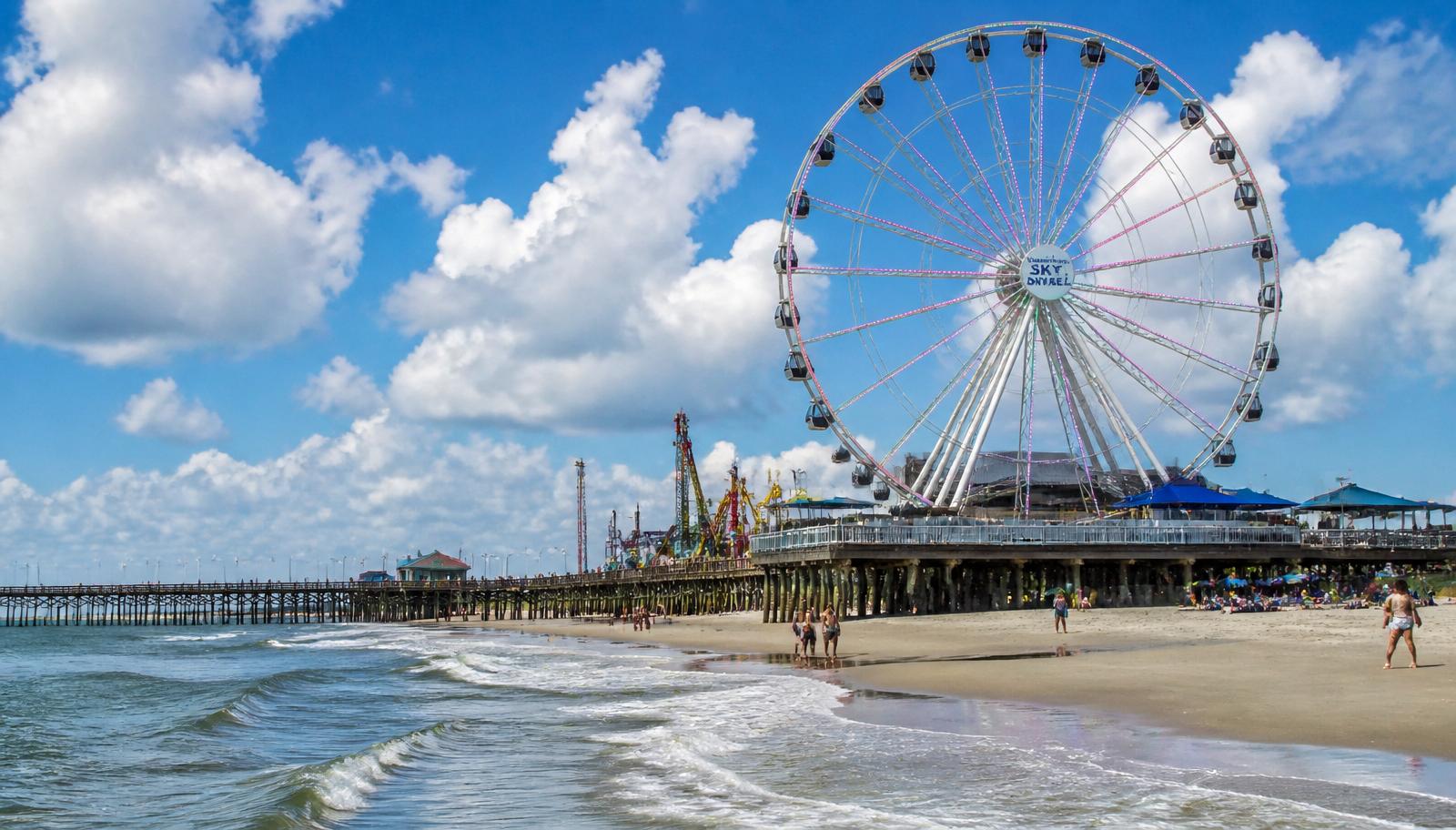 Carolina Beach Sky Wheel Ferris wheel on the boardwalk with the ocean and pier in the background